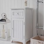 A crisp white freestanding bathroom storage furniture. A narrow