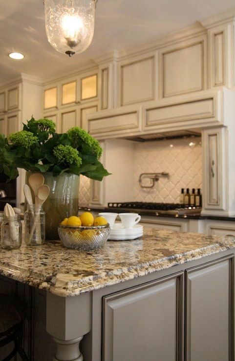 Antique ivory kitchen cabinets with blacK brown granite countertops