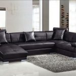 Black Leather Sleeper Sectional Sofa With Cushions And Silver Steel Legs  Placed On The White Floor