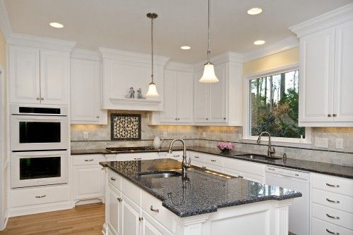 white speckle countertops with black appliances | Soft cream walls