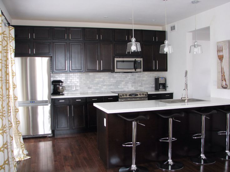Kitchen with dark cabinets and white quartz counters AND MARBLE