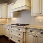 Love the antiqued cream cabinets and light countertop combo | For