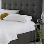 charcoal grey, upholstered headboard with white linens | House Ideas