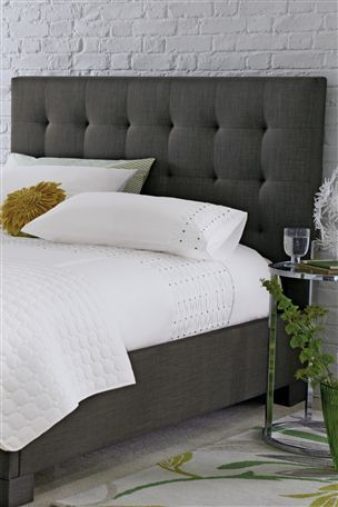 charcoal grey, upholstered headboard with white linens | House Ideas