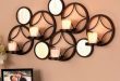 Décor your walls with appealing metal wall decor with candles or