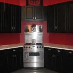 red walls black cabinets.. love it. Red Kitchen Cabinets, Black Cabinets,
