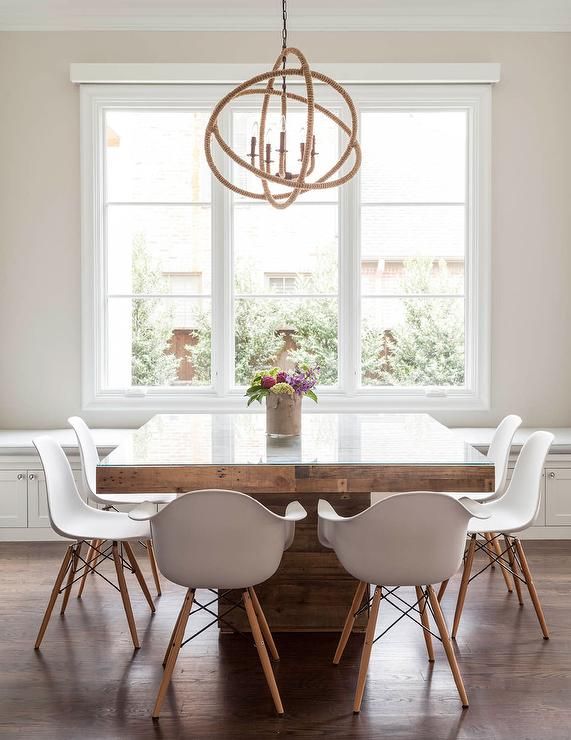 Contemporary dining room features a rope sphere chandelier hanging