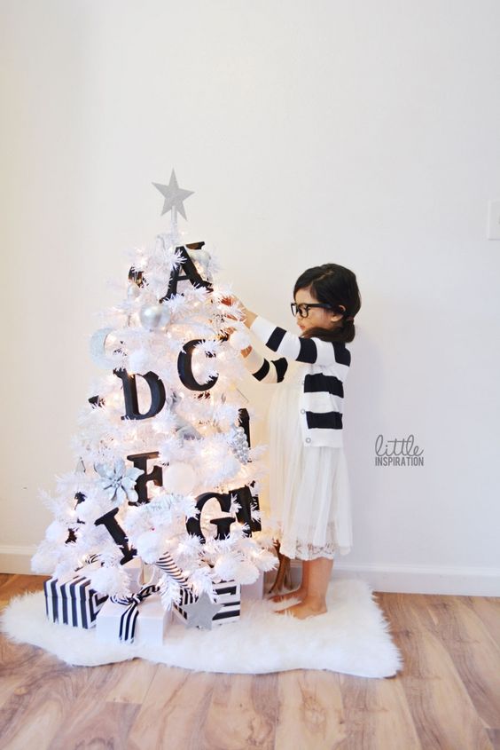 a small white tree decorated with black letters will help your kids learn them