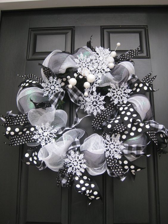 a black and white deco mesh wreath with snowflakes
