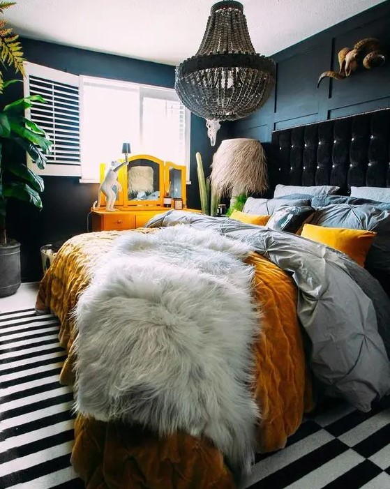 a colorful bed is a statement in this dark and moody bedroom, bright bedding helps with that