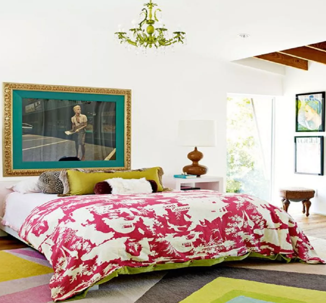 a colorful eclectic bedroom in a bright mix of colors, with bold artworks and a boho chandelier