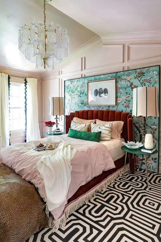 a colorful eclectic sleeping area done in aqua, emerald, burgundy and with touches of gold plus various prints