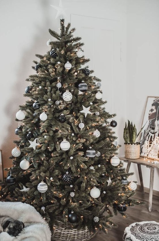 a lovely Christmas tree decorated with white pompoms, lights and a selection of gorgeous black and white ornaments and stars