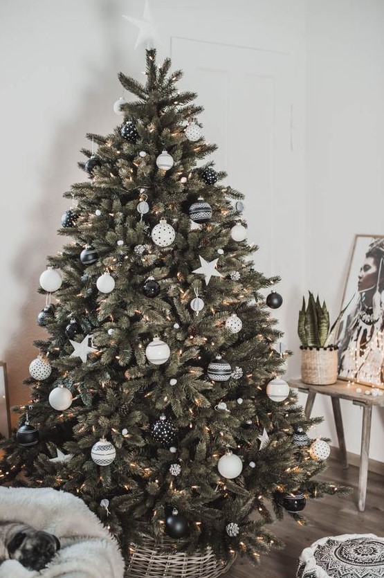 a lovely modern Christmas tree decorated with white pompoms, lights and a selection of gorgeous black and white ornaments and stars