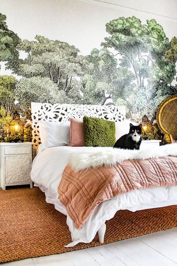 an eclectic bedroom with a bed with a carved headboard, a terracotta rug, nightstands with cage lamps and a papasan chair