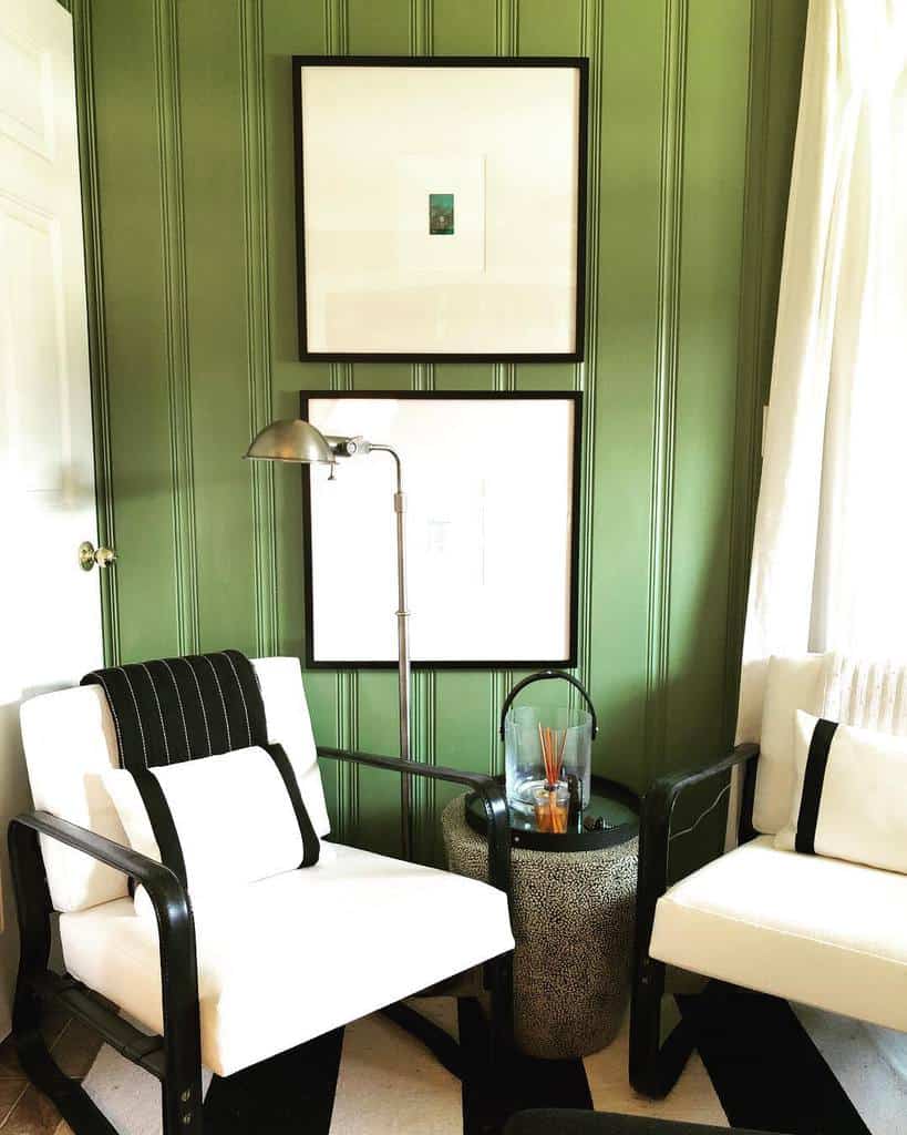green painted wall paneling, white sofas 