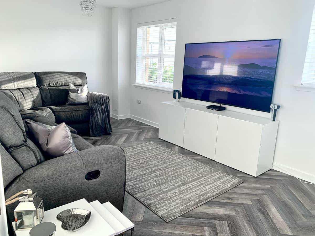 small living room, gray sofa, wall-mounted TV