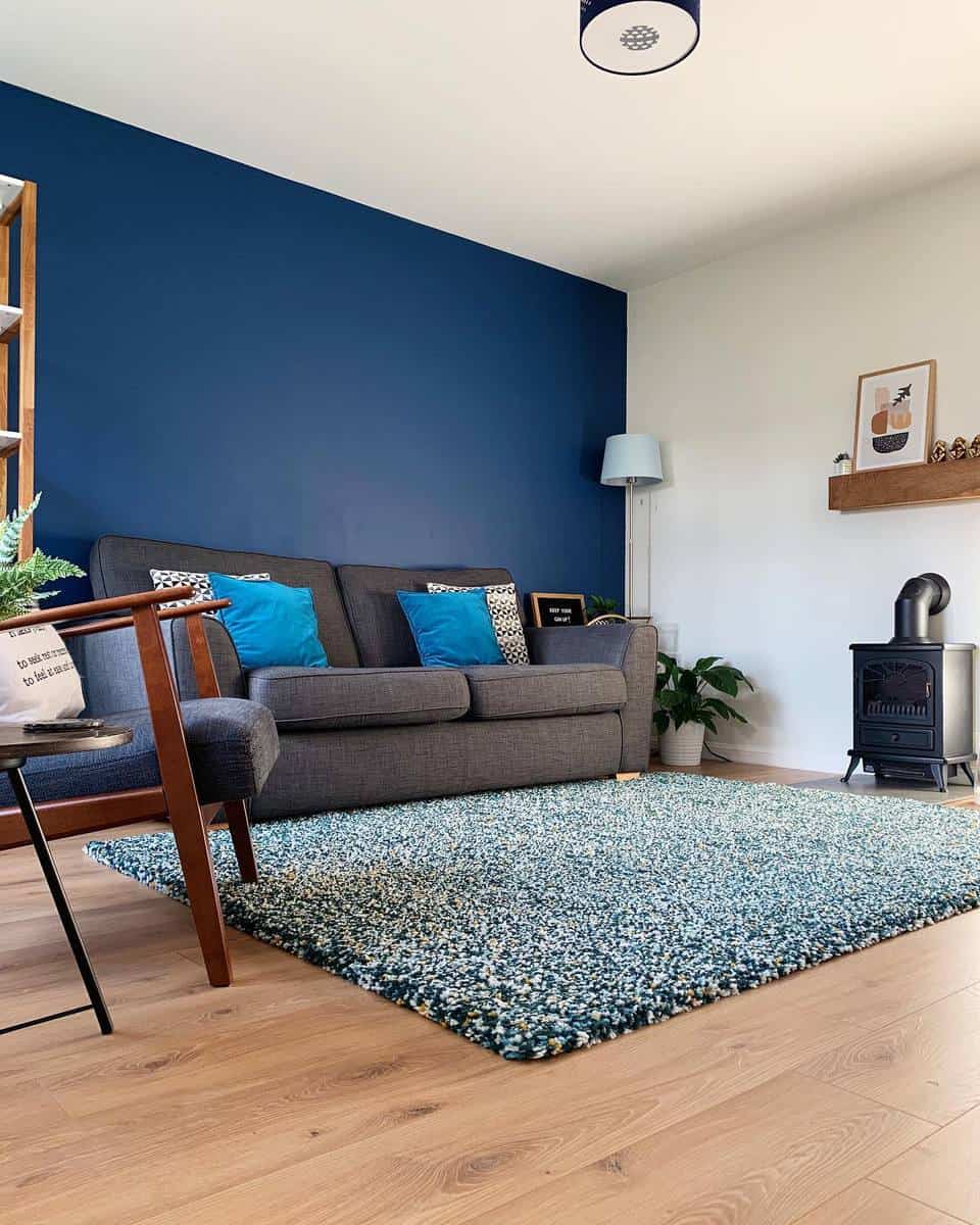 Blue accent wall, living room, gray sofa