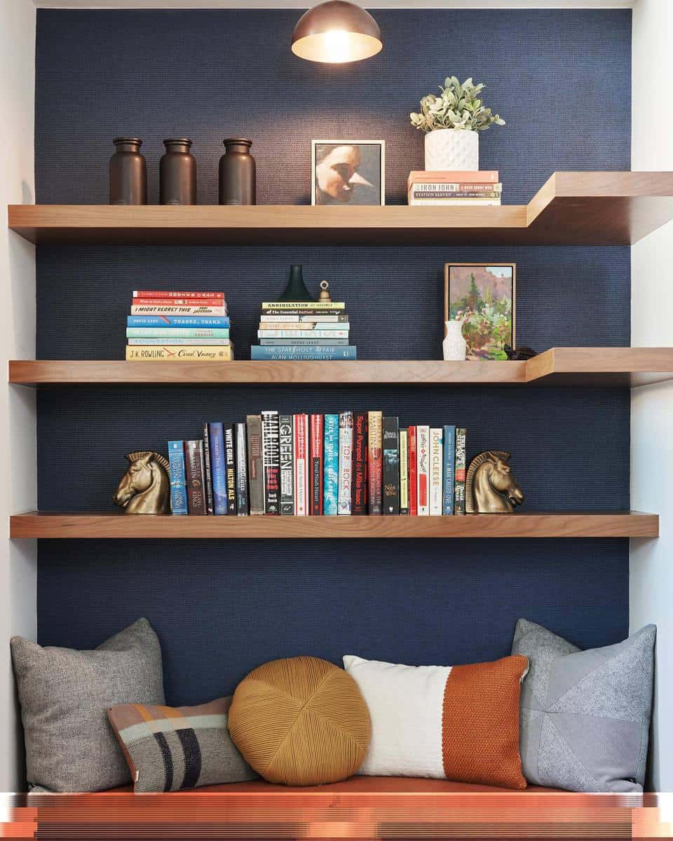 Blue wooden accent wall bookcases and metal bench