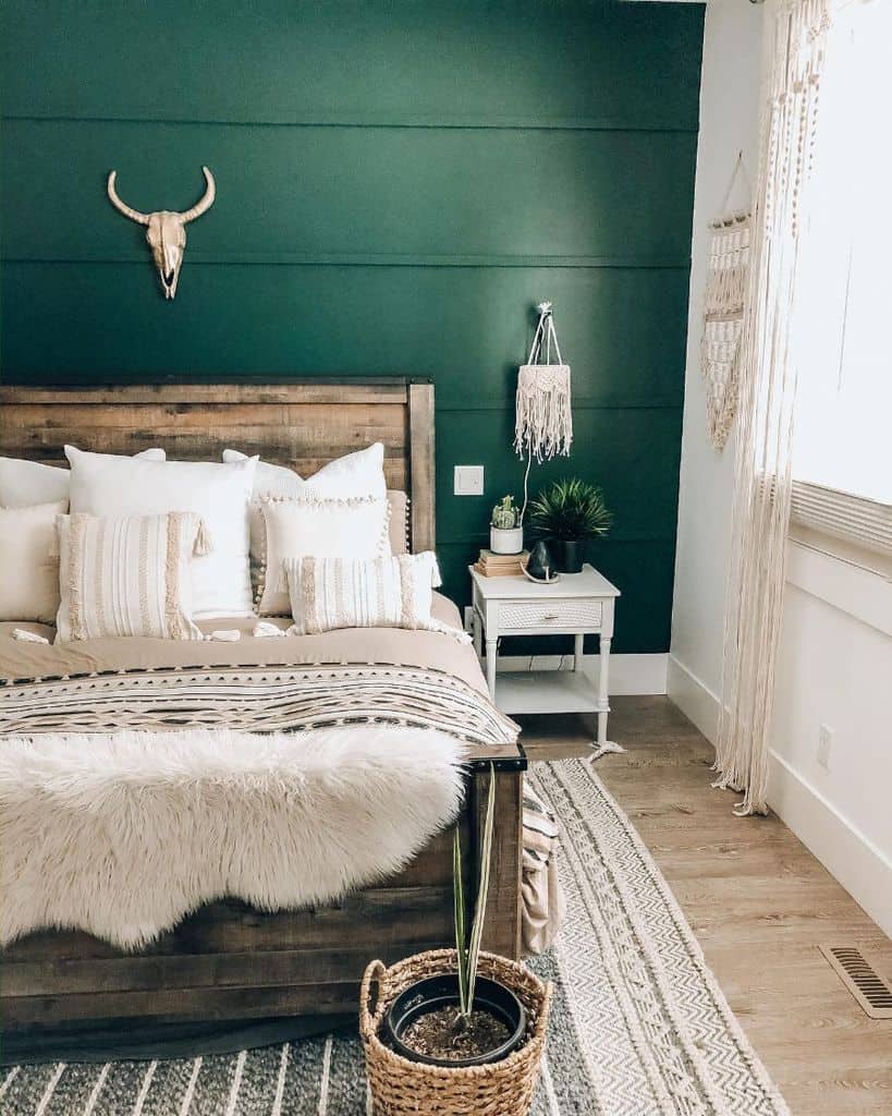 Farmhouse bedroom with accent wall and vintage wooden bed frame 