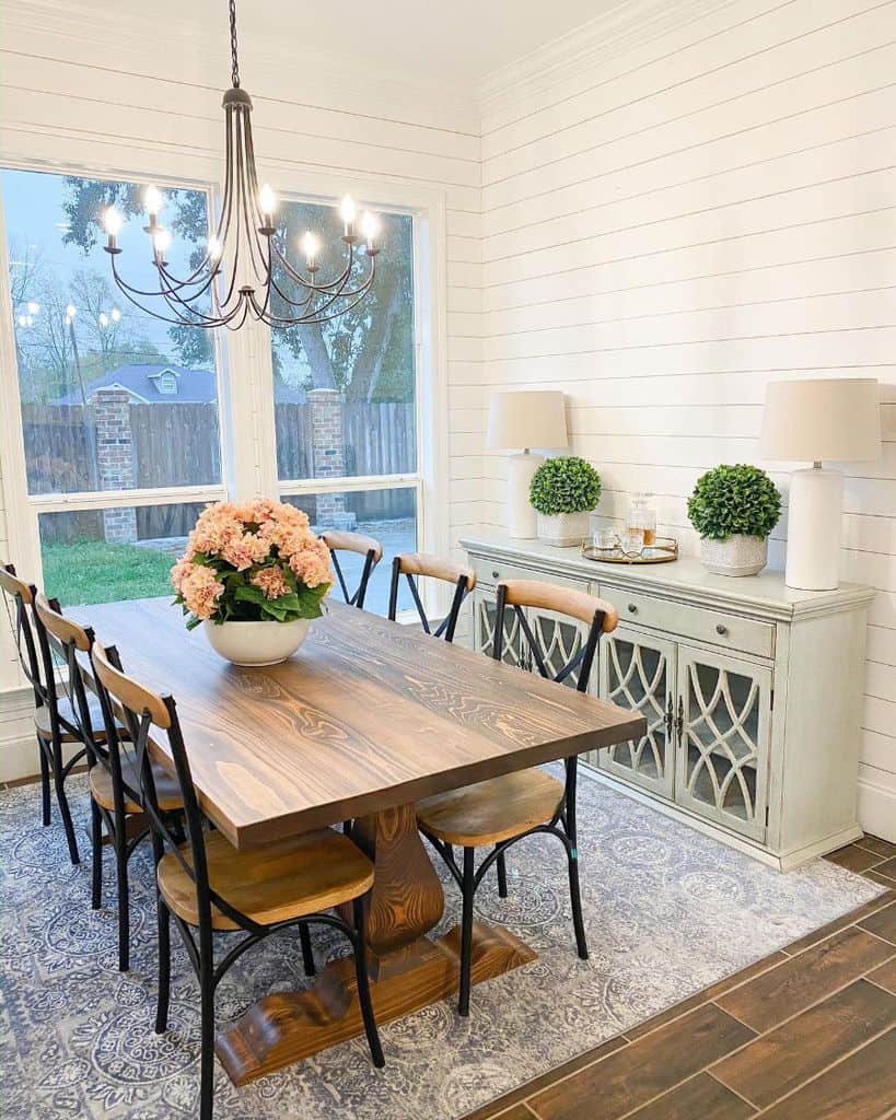 White shiplap dining room with vintage decor and furniture 
