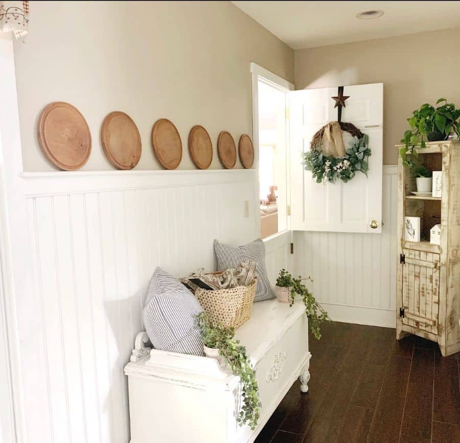 Small white living room with shiplap wall, vintage dresser and closet 