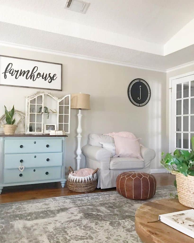 Vintage farmhouse living room with blue dresser and gray armchair 