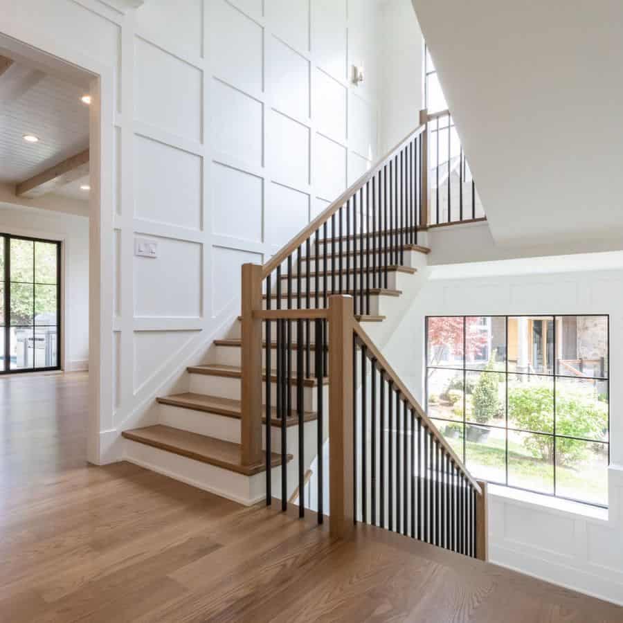 White wall paneling for the wooden stairs 