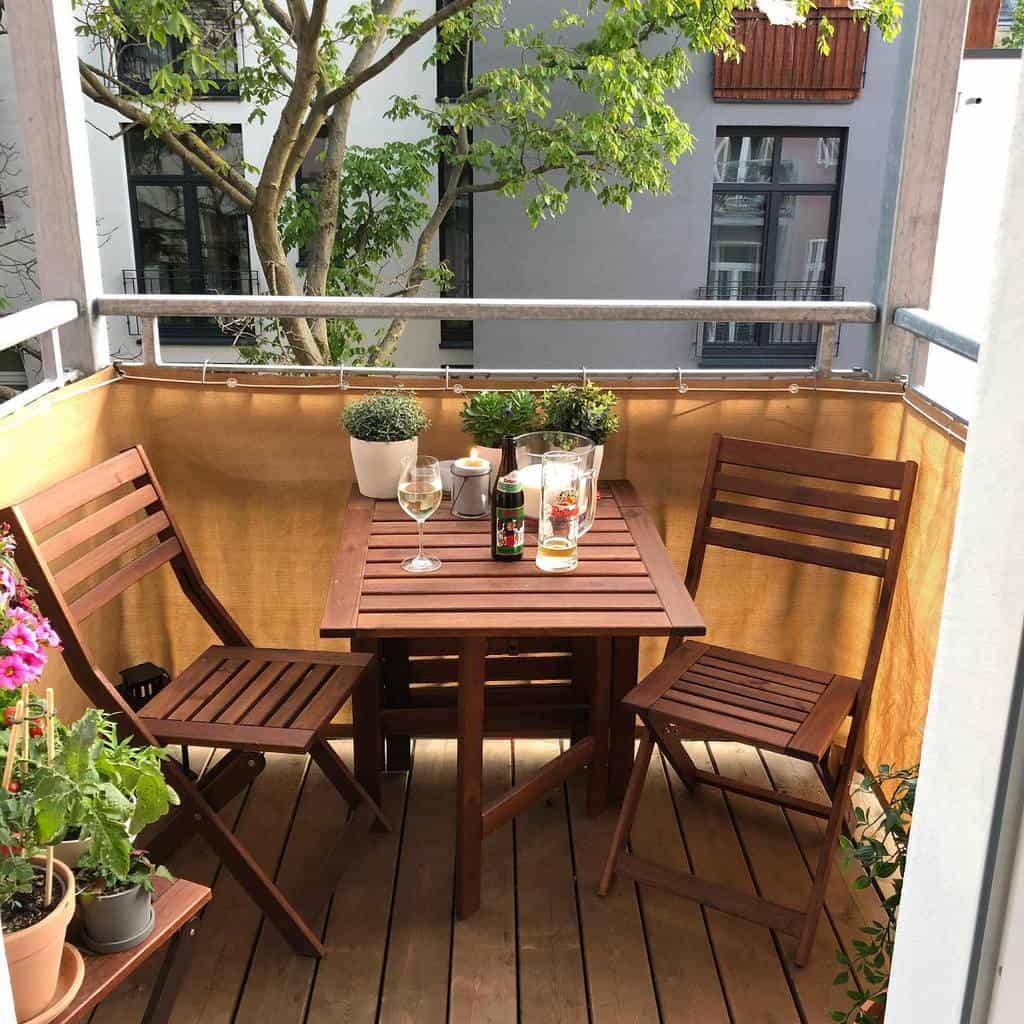 Small wooden terrace with balcony and terrace with table and chairs 