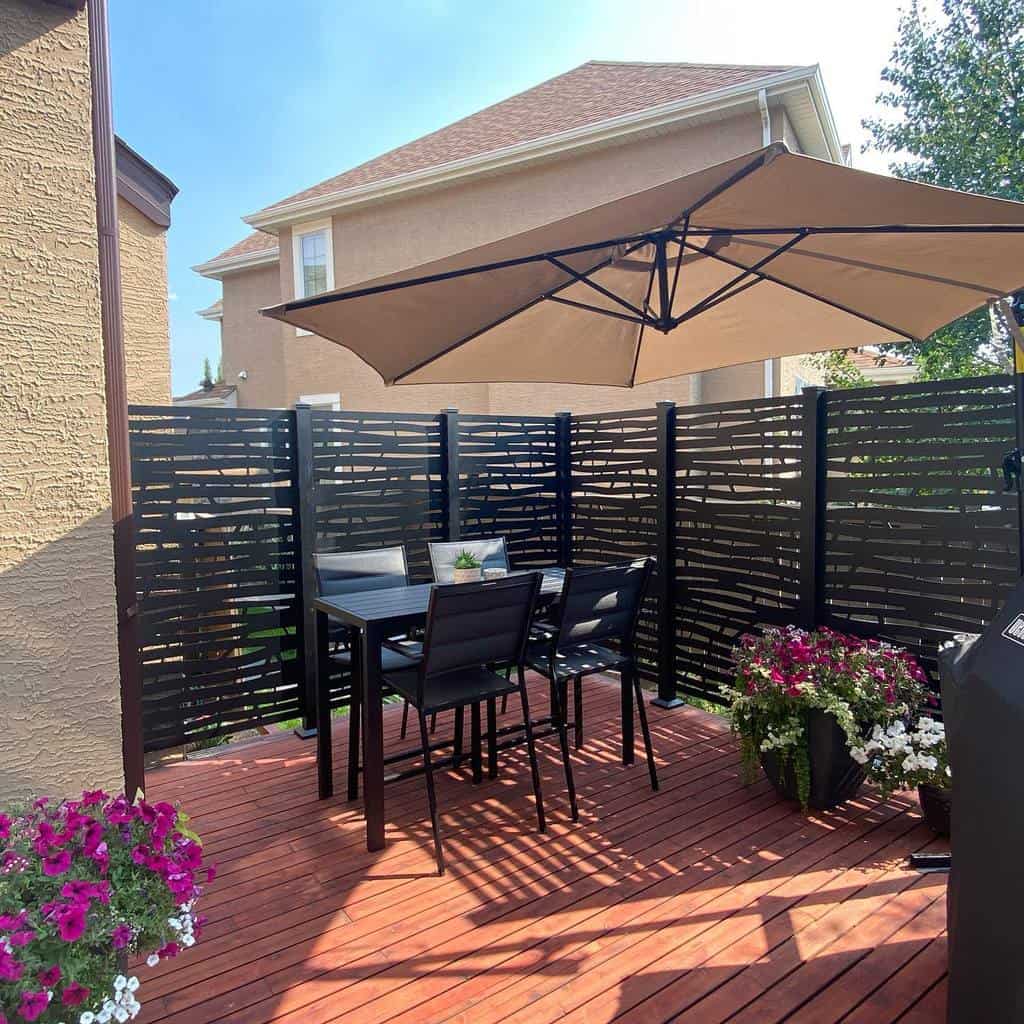 Deck terrace with black privacy fence and parasol