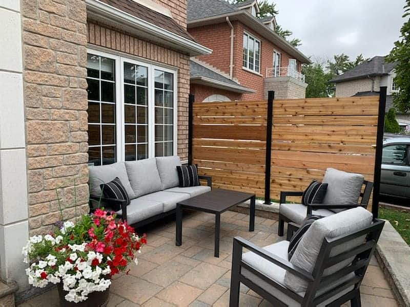 Small backyard patio with wooden privacy fence 