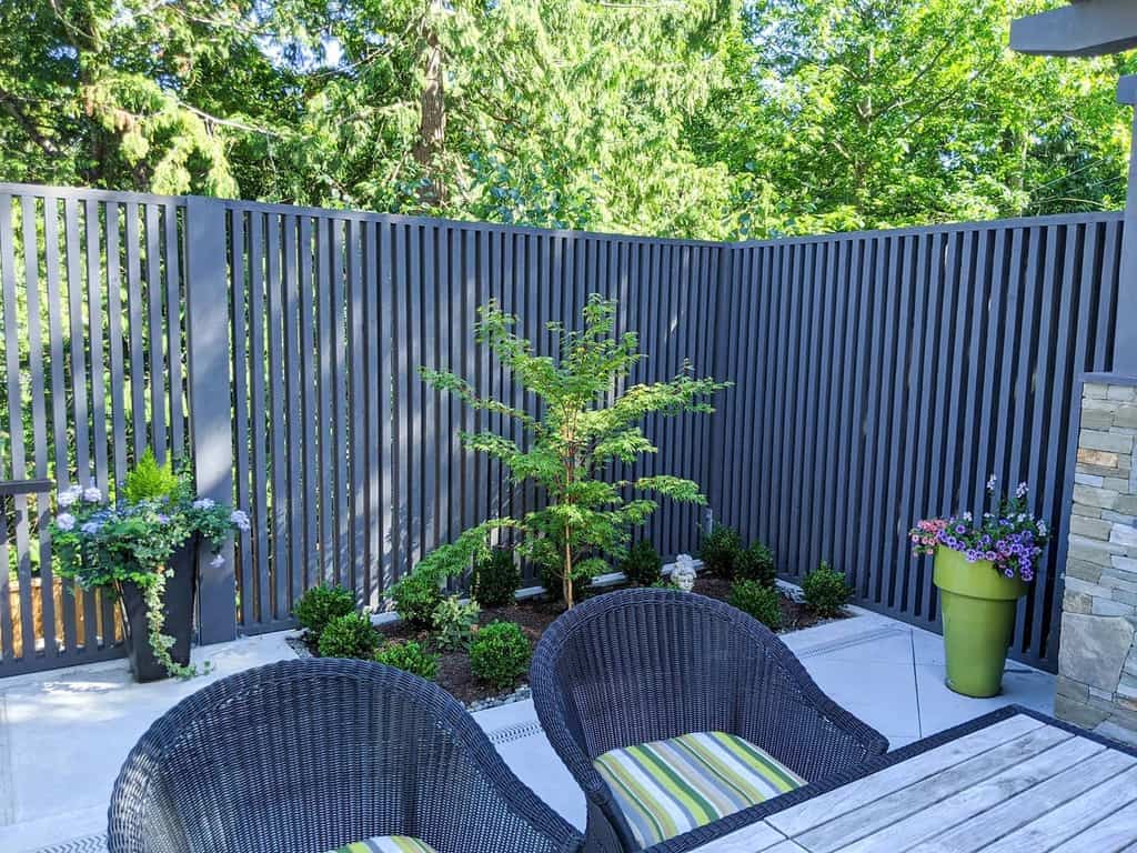 Luxurious terrace with a small garden and wooden picket fence 