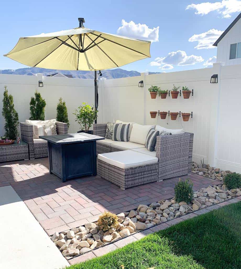 large, spacious outdoor terrace with parasol and wicker furniture 