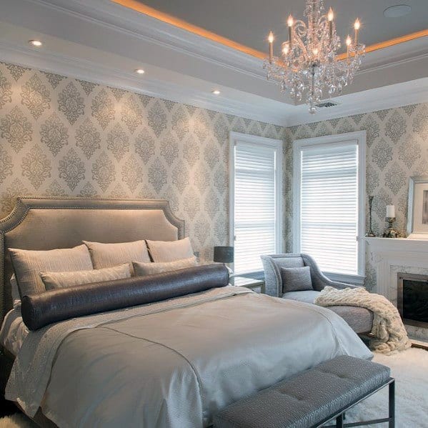 Gray bedroom print wallpaper, ottoman, gray chair 