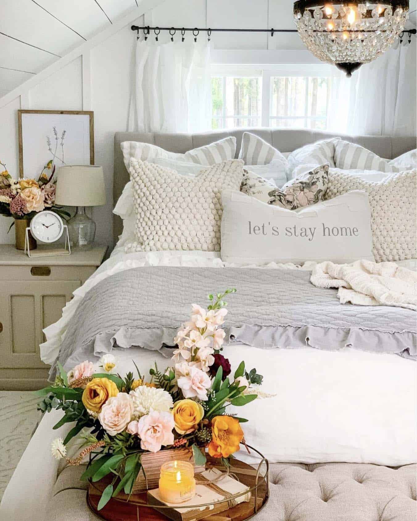 Soft and relaxing bedroom with flowers and a chandelier