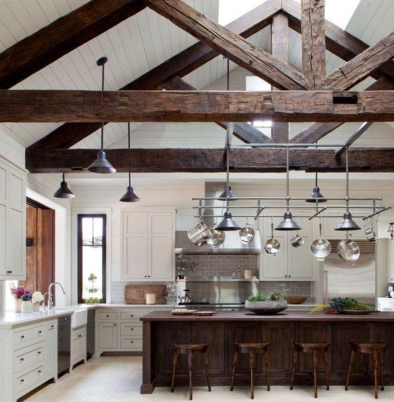 Rustic wooden beams give character to the ceiling of a country kitchen