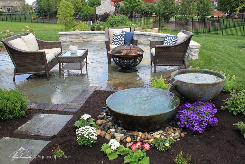 Feature a compact water fountain for soothing sounds in your Small Patio Design