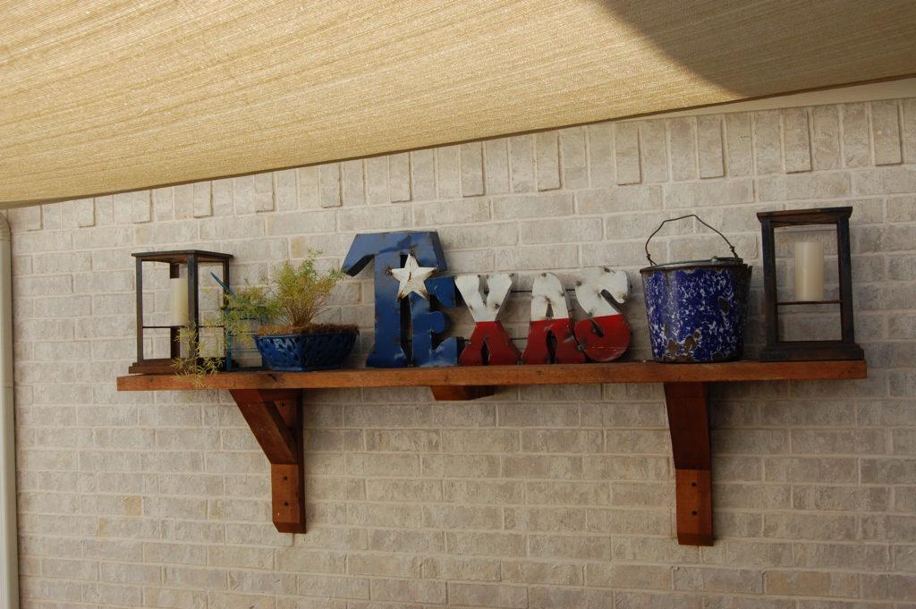 Use wall-mounted shelves for decorative accents in your Small Patio Design