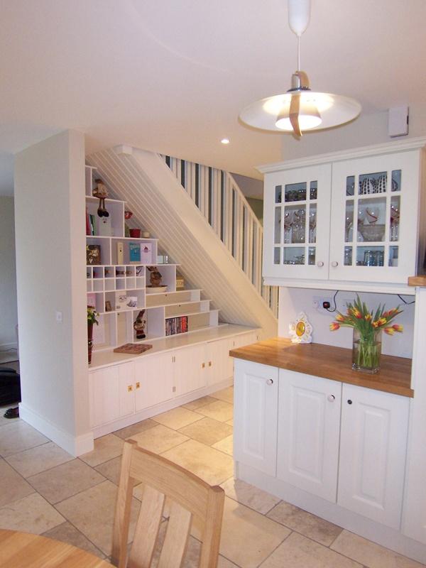 Display cookbooks on shelves in your under stairs kitchen for inspiration and style