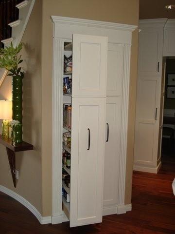 Utilize a pull-out pantry in your under stairs kitchen for organized, hidden supplies