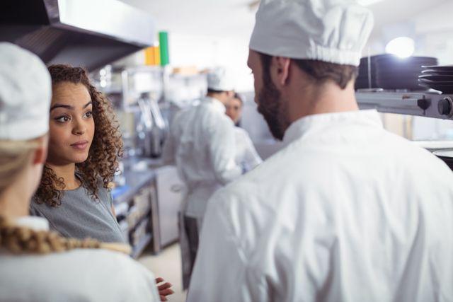 Open communication fosters teamwork and efficiency among staff in the Industrial Kitchen