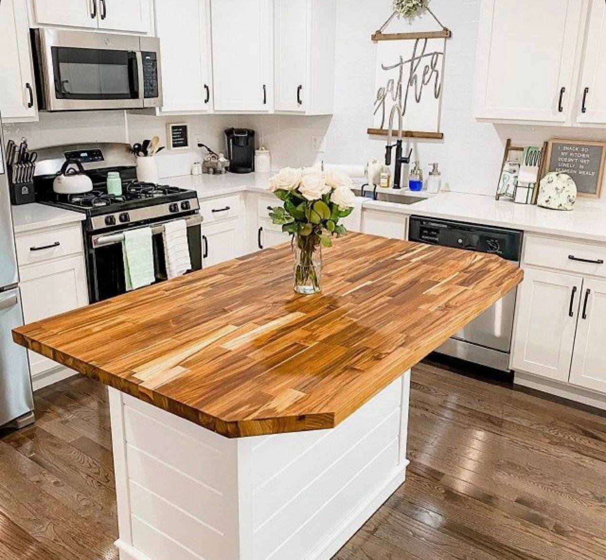 An island with a butcher block‍ top enhances kitchen prep space in country kitchens