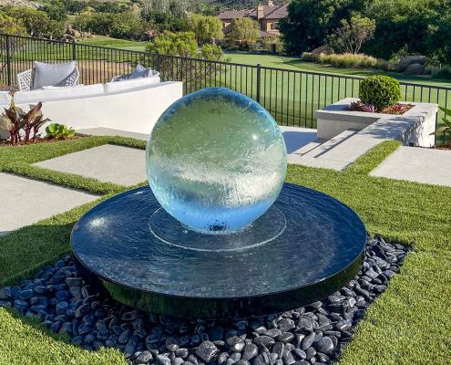 Add a contemporary water feature to promote relaxation in your modern backyard