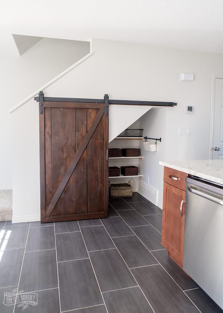 Implement a sliding door for your Under Stairs Kitchen to save space and enhance style