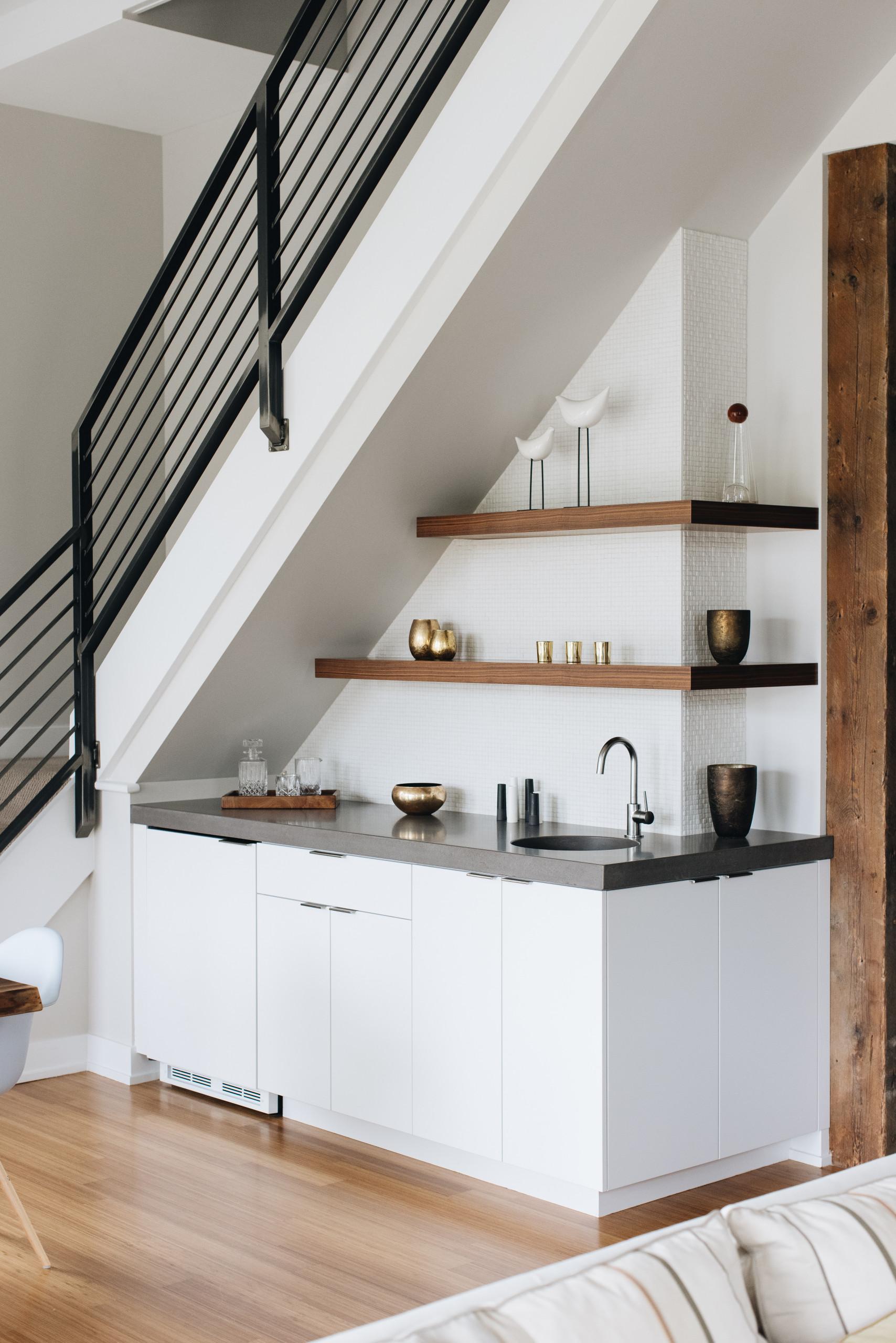 Use mirror finishes in your under stairs kitchen to enhance the sense of space