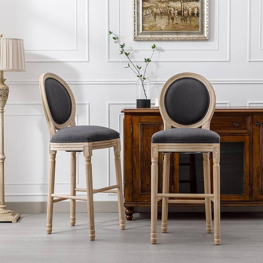 Wooden stools provide inviting seating around the countertop in a country kitchen