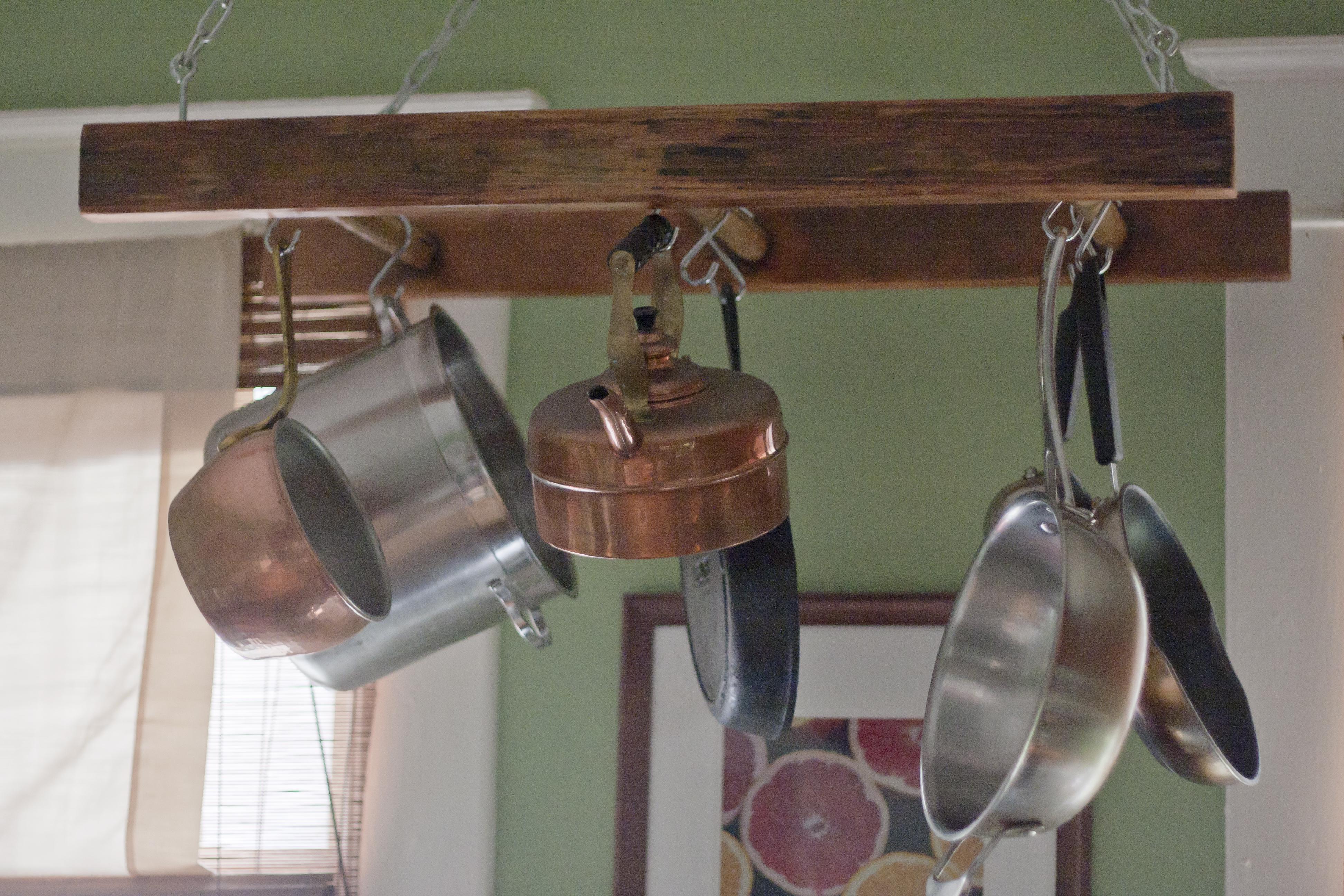 Use a ladder-style rack in your under stairs kitchen for hanging pots and pans