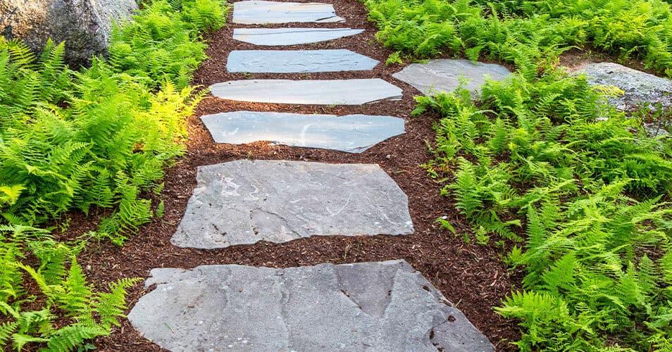 Rustic stone ‌pathways blend nature with structured Landscaping⁢ Design⁣ for earthy charm