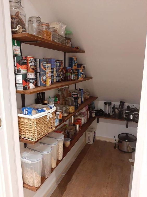 Use transparent storage containers in your under stairs kitchen for a tidy look