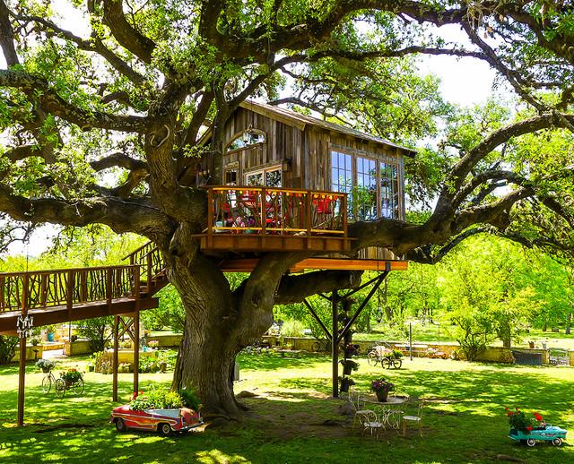 Add a treehouse for a whimsical touch in your backyard design